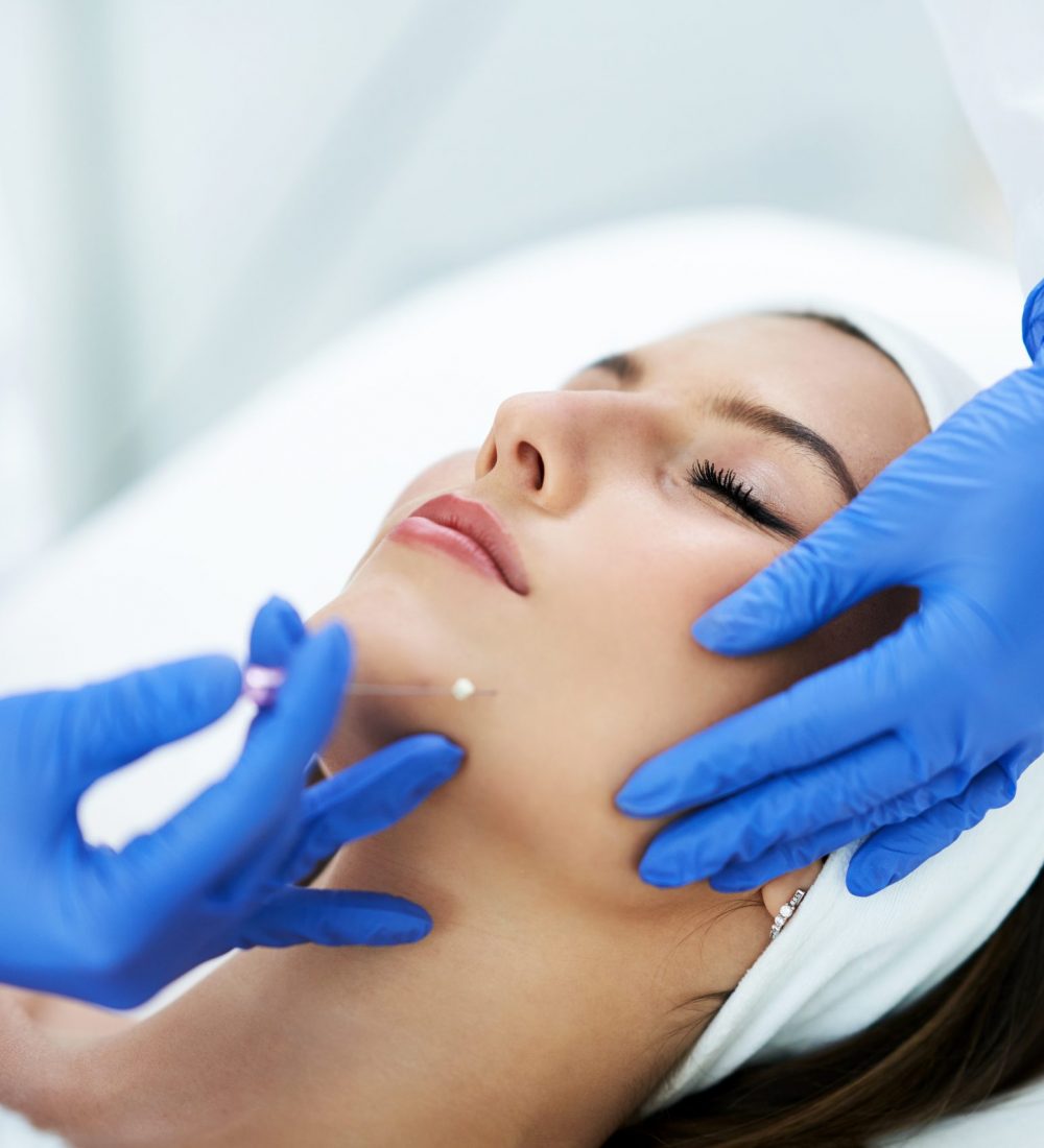 Beautiful young woman getting polydioxanone thread lifting at beauty salon.